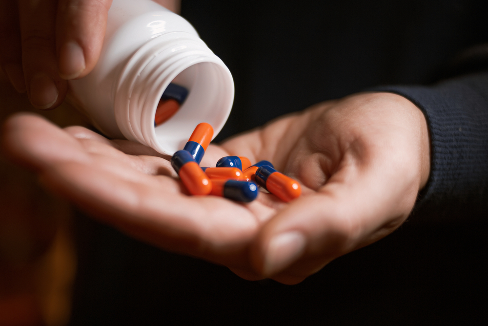 medicine capsules poured from bottle