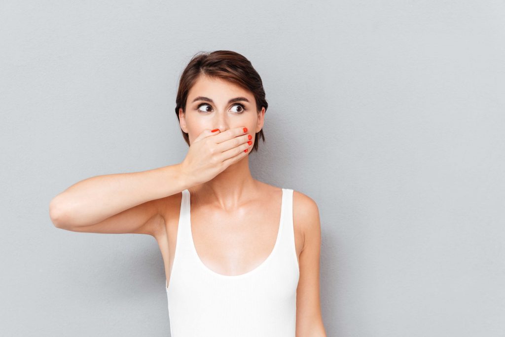 woman covering mouth with one hand