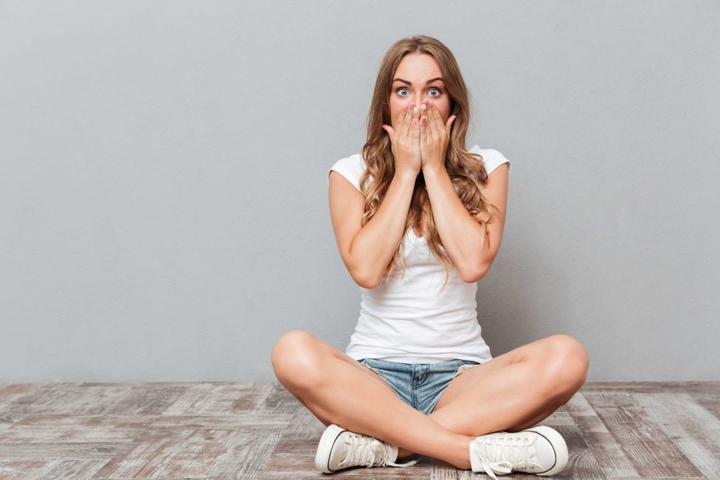 shocked woman covering mouth