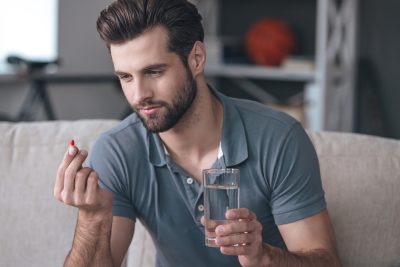 man inspecting medication