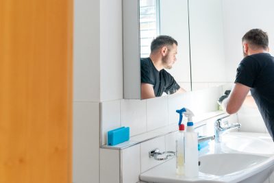 man cleaning bathroom