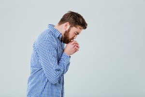 man coughing